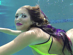 Busty August Ames dives in deep for an underwater tease